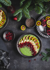 Green smoothie bowl with kiwi, banana and pomegranate.