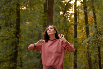 young woman in casual clothes is relaxing in an old park