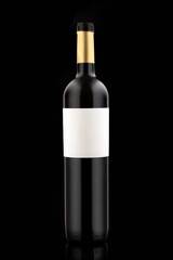 Long tall Bottle of red expensive wine on a black background vertical close-up photo. blank label