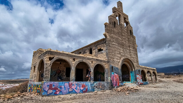 Exterior view on concrete church of abandoned leper village of Sanatorio de Abona near Abades beach, east coast of Tenerife Spain. An unnfinished project of leprosy hospital. Ghost town. Cross on wall