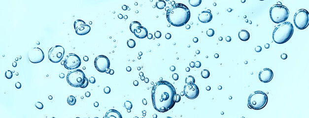 Close up macro Aloe vera gel cosmetic texture blue background with bubbles. Lemongrass gel skincare product. antibacterial liquid with aloe vera, moisturizing. Safe and environmental friendly.