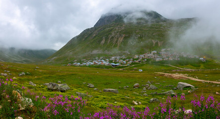 A winding mountain road and plateaus between mountains in late spring on a foggy day on the Greene...