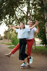 Happy mom and daughter walking down the street on a sunny day. The concept of family, parenting and relationships.