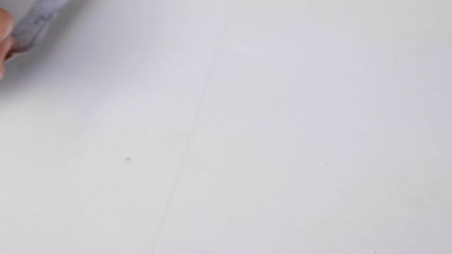 Caucasian Hands Making Marking on White Paper with Tape Measure, CU.