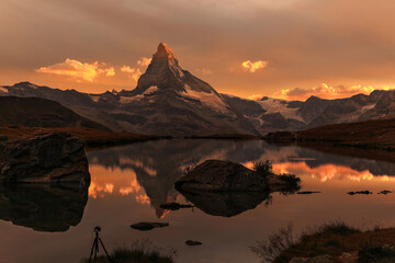 Sunset with dramatic alpenglow at the high mountain lake Stelisee with the famous Alps peak...