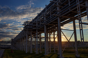 The building of an industrial enterprise in the sunset sunlight. A beautiful horizontal photograph of an industrial landscape.