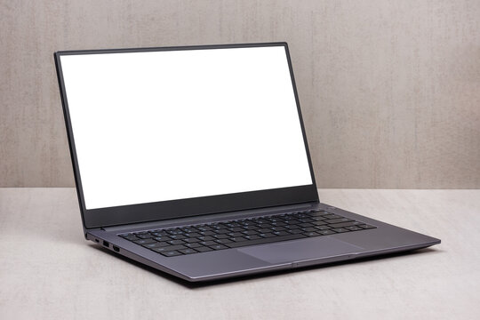 white mock up on a laptop screen on a gray background close up with clipping path