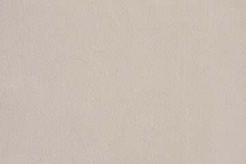 Saturated pastel gray beige colored low contrast Concrete textured background. Empty colourful wall...