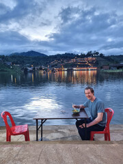 Tourist man eating noodle soup at Ban Rak Thai, A Chinese Settlement In Mae Hong Son, Thailand