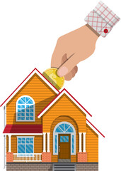 Hand put coin in piggy bank house