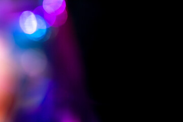 Blur colorful rainbow crystal light leaks on black background. Defocused abstract multicolored...