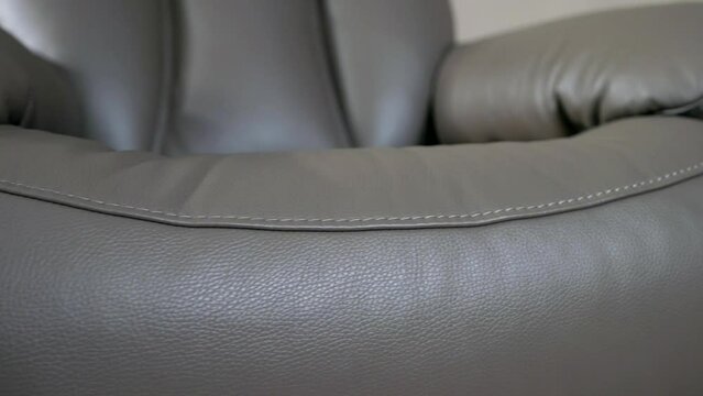 exclusive leather recliner chair in modern shop of furniture of designer, expensive interior