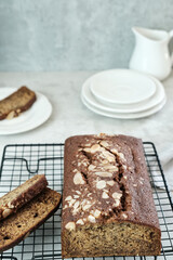 Homemade banana bread sliced on cooling rack, close-up, selective focus image.
