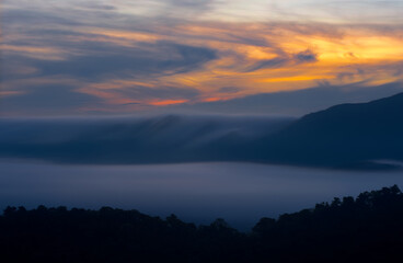 Aerial view Beautiful  panorama of morning scenery Golden light sunrise And the mist flows on high mountains forest. Pang Puai, Mae Moh, Lampang, Thailand.