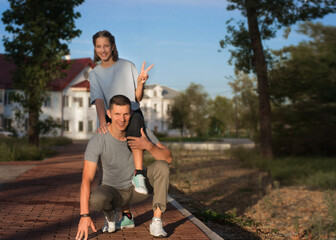 Happy father and daughter play outside on a sunny day. The concept of love and happiness.