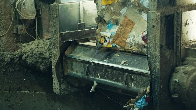 Blocks of waste paper on conveyor belt transported to production workshop. 
Paper Recycling Facility.
Cardboard manufacturing process from waste paper. 4K