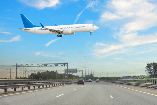 Low-flying aircraft over the expressway before landing at the airport.