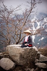 Portrait os a young caucasian boy seven year old dressed as Samurai in black and white Kimono and...