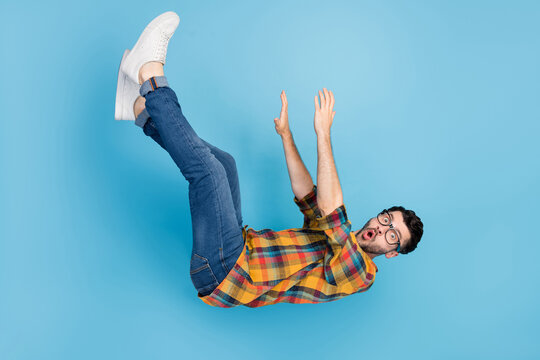 Full body profile photo of impressed terrified person falling open mouth isolated on blue color background