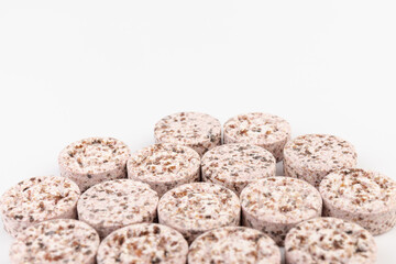 Heap of medicine colored pills, tablets on a white background