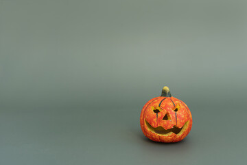 Colourful halloween pumpkin on green background with copy space. Minimal autumn fall holidays concept