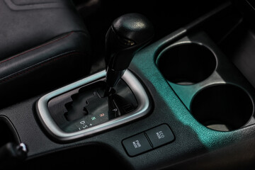 Fototapeta na wymiar automatic transmission shift selector in the car interior. Closeup a manual shift of modern car gear shifter. 4x4 gear shift 