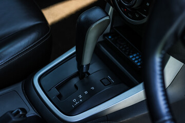 Obraz na płótnie Canvas automatic transmission shift selector in the car interior. Closeup a manual shift of modern car gear shifter. 4x4 gear shift 