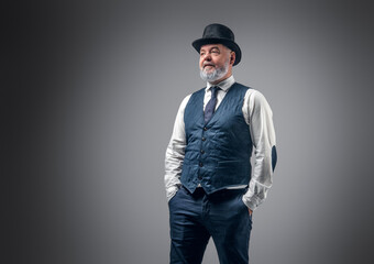 Shot of elderly man dressed in stylish old fashioned costume with top hat.