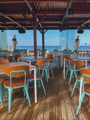 Tables at a beach restaurant with sea views right next to the sand (chiringuito)
