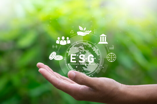 ESG text and Environmental concept in hand of human, social, and governance in sustainable and ethical business on the network connection on nature background.