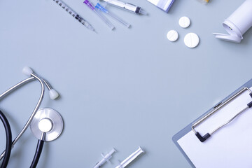 Medical stethoscope and pills on colored background with copy space. Top view of abstract medical...