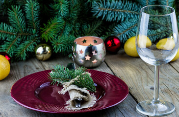 Christmas (New Year) table appointments. Fork and knife decorated thuja branches and twine bow with...
