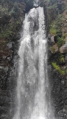 Abstract Defocused Blurred Background photo of scenery of waterfalls and mossy cliffs, one of the popular tourist destinations in the Cicalengka area - Indonesia. Not Focus