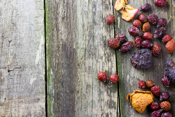 Top view of dried berries on old grunge wooden background with place for your text