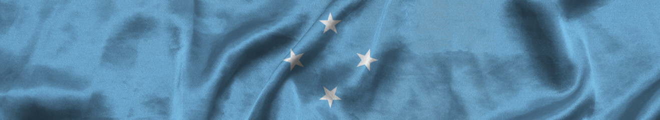 Elongated national flag of Micronesia with a fabric texture fluttering in the wind. Federated States of Micronesia flag for website design. 3d illustration