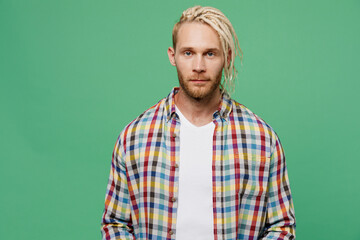 Young serious calm cool european stylish caucasian blond man with dreadlocks 20s he wear casual shirt isolated on pastel plain light green color background studio portrait. People lifestyle concept.
