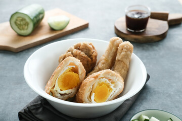 Pempek, Empek-Empek, traditional food from South Sumatra, Indonesia. This fish-based food is very popular. Served with cuko sauce and cucumber slices.
