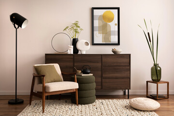 Interior design of harmonized living room with brown commode, design boucle armchair, pouf, lamp,...