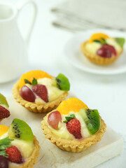 Delicious mini pie with fresh fruits, close up
