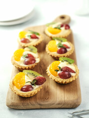Delicious mini pie with fresh fruits, close up
