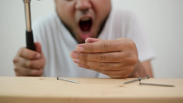 The carpenter was injured by hammer and nails. He misused the hammer and stuck it in his hand. Accidents during work require accident insurance. Unsafe concept.