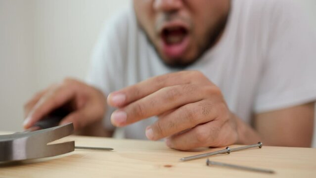 The carpenter was injured by hammer and nails. He misused the hammer and stuck it in his hand. Accidents during work require accident insurance. Unsafe concept.