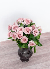 bouquet of beautiful pink roses with water drops in a vase