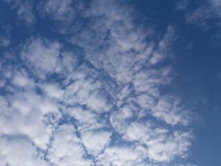 White clouds almost cover the blue sky or bright blue sky and are full of white clouds during the day
