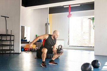 Sportive man workout with kettlebell doing exercises