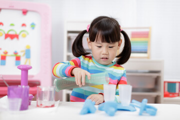 young girl pretend playing food preparing at home