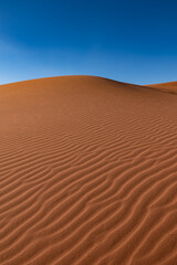 Fototapeta na wymiar Dunes and patterns in the sand in the Wadi Rum desert, sunny day, Jordan