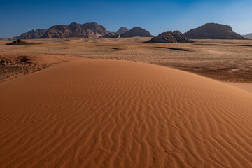 Fototapeta na wymiar Dunes and patterns in the sand in the Wadi Rum desert, sunny day, Jordan