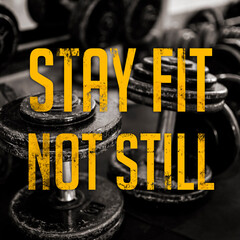 Stay fit not still message - with dumbbells on the rubberized floor as background. Gym motivation and hype words. Industrial grunge design.