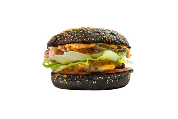 Hamburger with black bun, cheese and salad. Transparent.